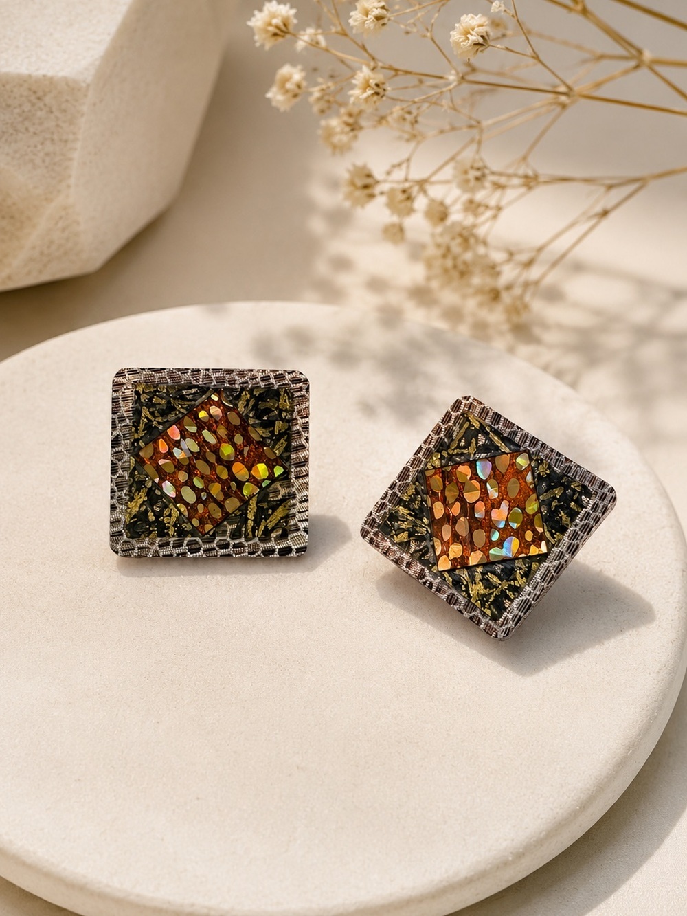 A pair of square lightweight earrings pattern snakeskin, with shiny gold spots.